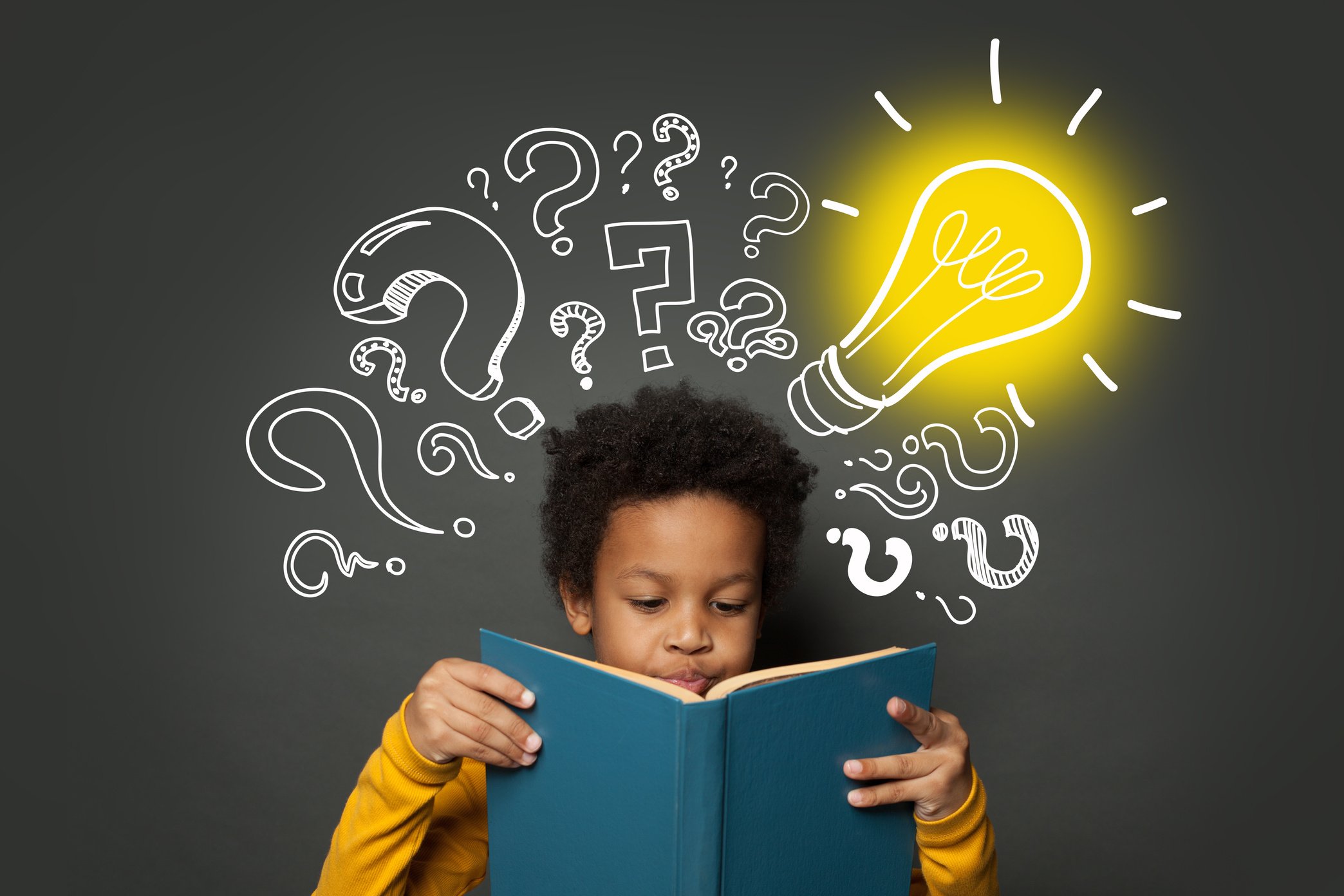 Intelligent black kid student reading book and having idea. Brainstorming and idea concept